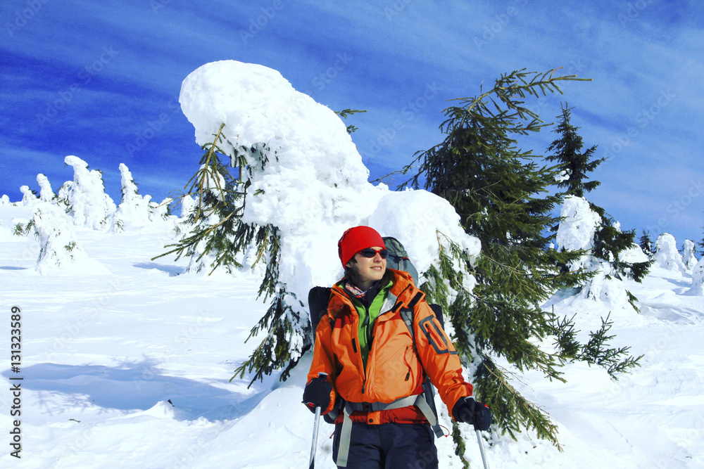 Winter hiking in the mountains on snowshoes with a backpack and