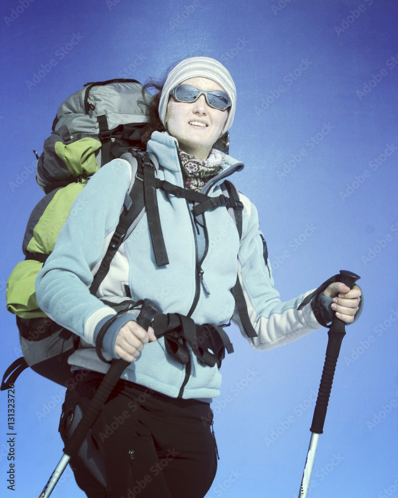 Obraz premium Winter hiking in the mountains on snowshoes with a backpack and