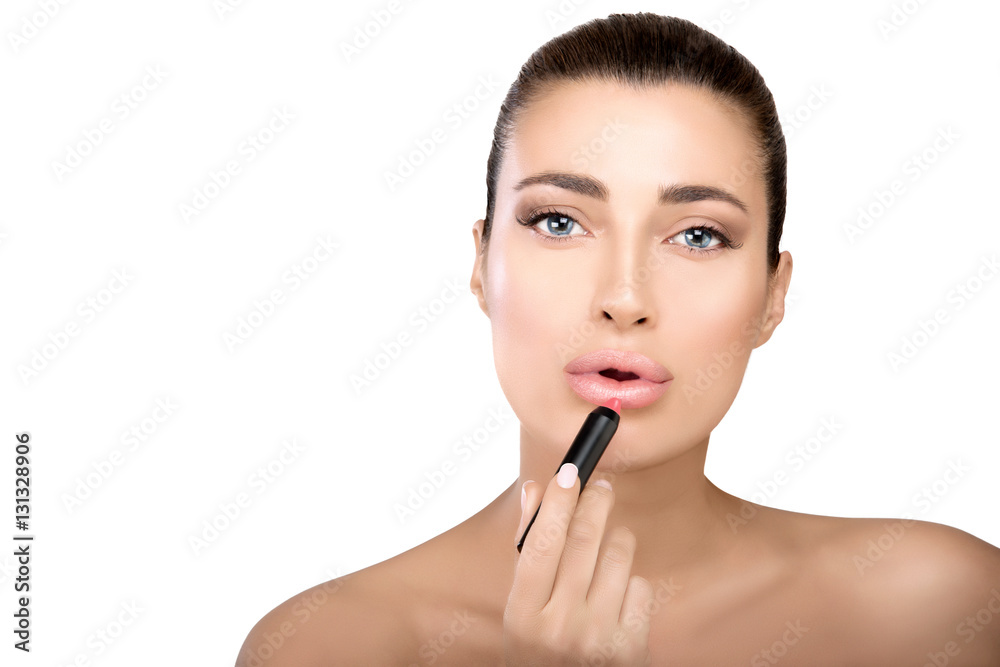 Beauty model applying lipstick to her lips