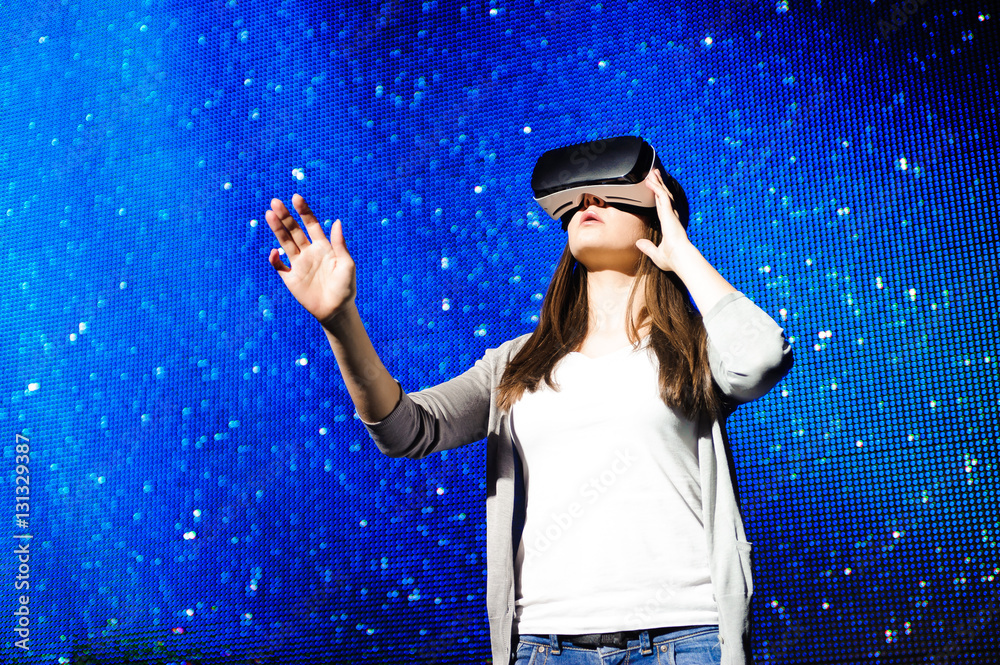 a beautiful girl wearing a virtual reality device, standing on t a beautiful girl wearing a virtual reality device, standing on t