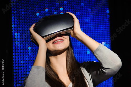 Double exposure of happy woman using VR-headset glasses for virt photo