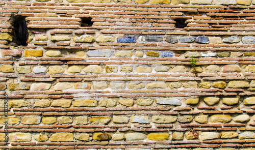 Wall made of stone or brick in the archaeological ruins of the ancient Roman town Velia, Campania. Italy photo