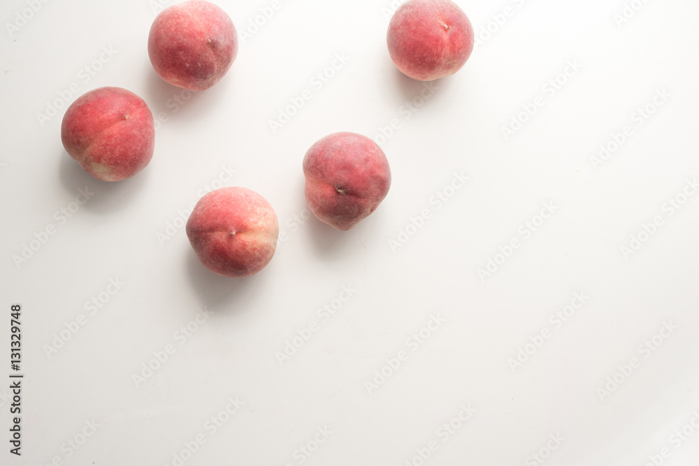 High angle view of five white peaches scattered on table