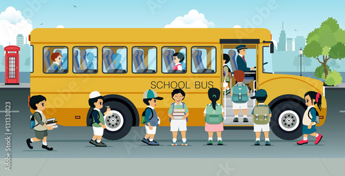 Students are walking on the bus parked on the street.