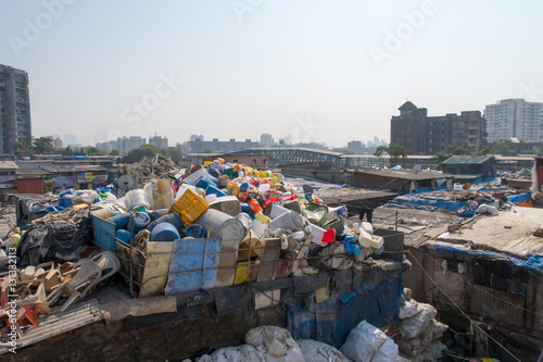 india mumbai slum people and children working and living laundry, plasitic
