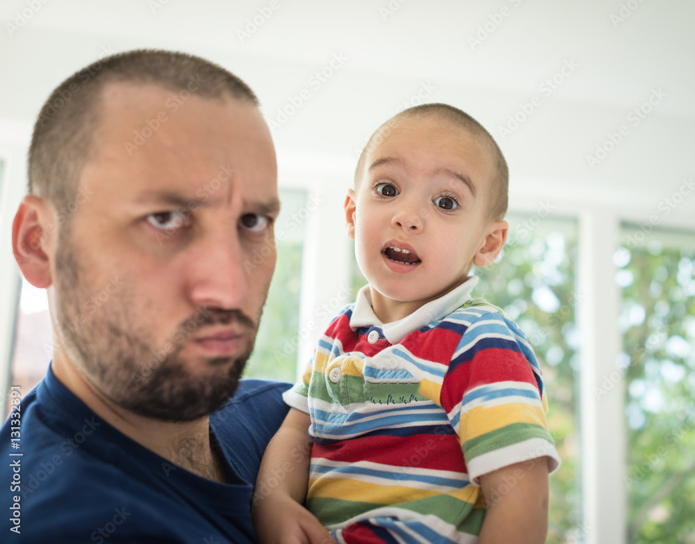 Father and little cute son making grimaces Father and little cute son making grimaces