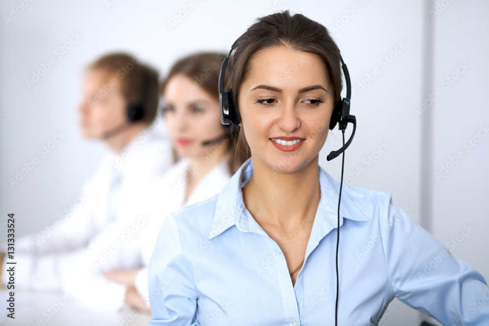 Call center. Focus on beautiful woman in headset Call center. Focus on beautiful woman in headset