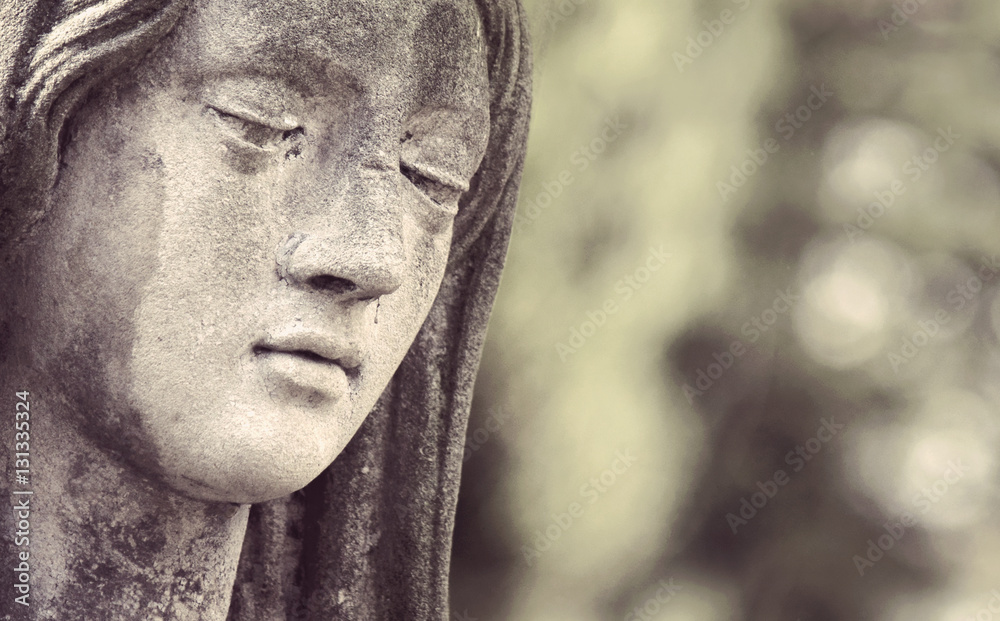 Statue of Virgin Mary in tears (sadness, regret, fear, religion,