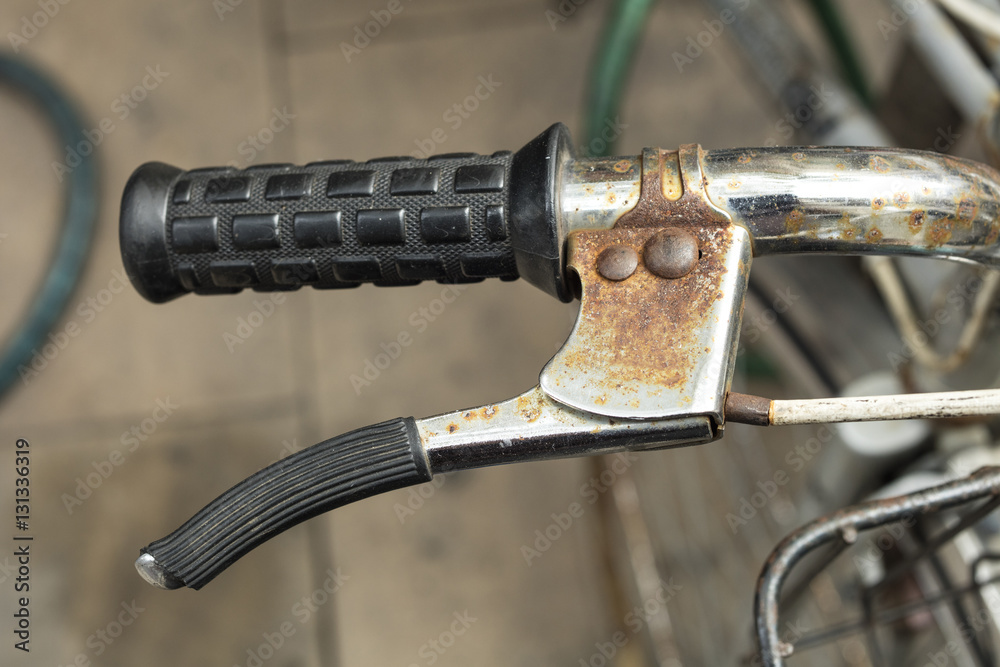 Detail of roasted handlebar and brake of an old, vintage bicycle