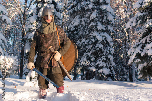 medieval warrior in the winter forest in historical armor