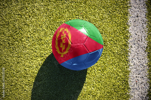 football ball with the national flag of eritrea lies on the field