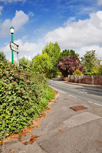 Blackberry brambles line a rural street by the Parish Church in the pretty village of Hollingbourne in Kent, England photo