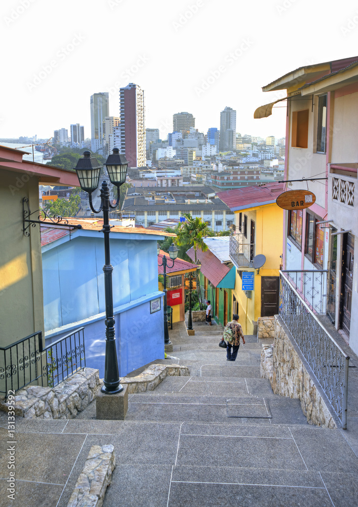 Naklejka premium View of the stairs going down the Santa Ana hill and houses in the neighborhood, and Guayaquil in the background.