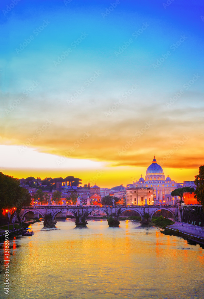 Obraz premium St. Peter's cathedral over bridge and river in Rome at orange sunset, Italy