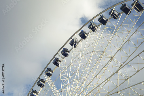 Ferris wheel with blue cloudy background