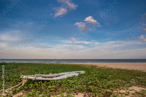 Old surf board on a deserted beach, Cherating, east cost of Malaysia photo