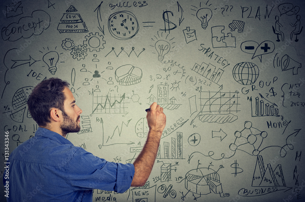 man writing on the wall business calculations plan. man writing on the wall business calculations plan.