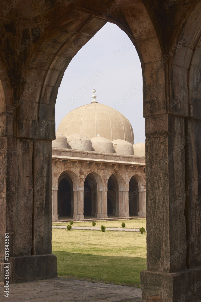 Inner courtyard and covered prayer hall of the ancient mosque of Ashrafi Mahal Mosque in the hilltop fortress of Mandu in Madya Pradesh, India. 15th Century AD