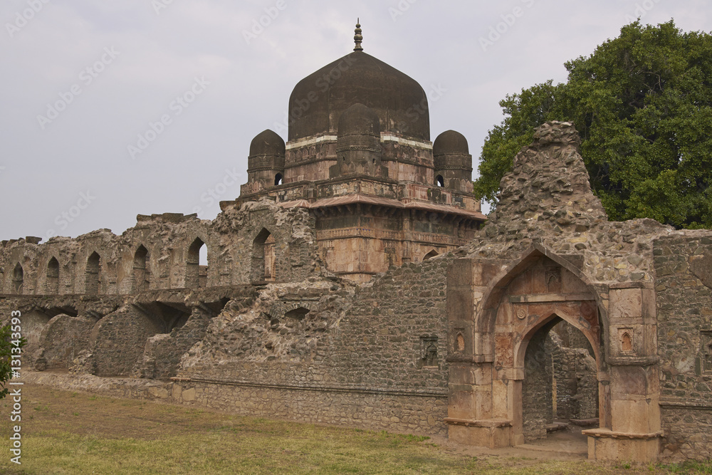 Darya Khan's tomb in the hilltop fortress of Mandu. Building with central dome and a smaller dome on each corner in a walled compound. 16th Century AD