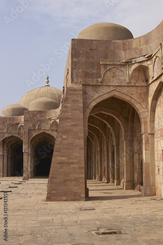 Inner courtyard and covered prayer hall of the ancient mosque of Ashrafi Mahal Mosque in the hilltop fortress of Mandu in Madya Pradesh, India. 15th Century AD