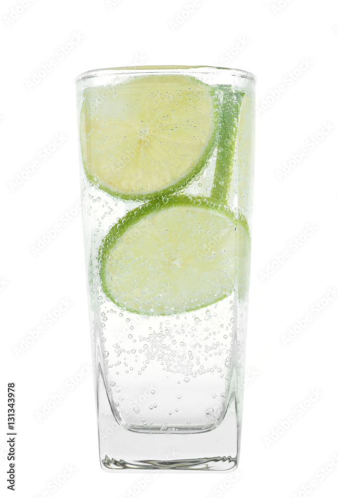 Full glass of fresh cool tonic with lime fruits isolated on whit Full glass of fresh cool tonic with lime fruits isolated on whit