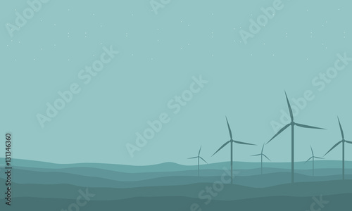 Silhouette of many windmill on farm scenery