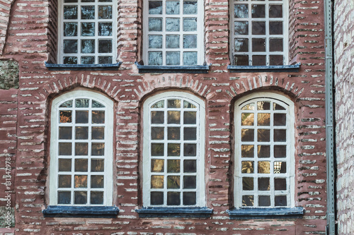 Beautiful stone and bricks facades with different sizes windows