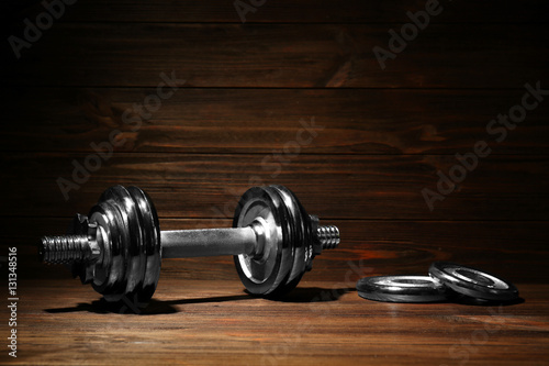 Wallpaper Mural Metal collapsible dumbbell on wooden background Torontodigital.ca