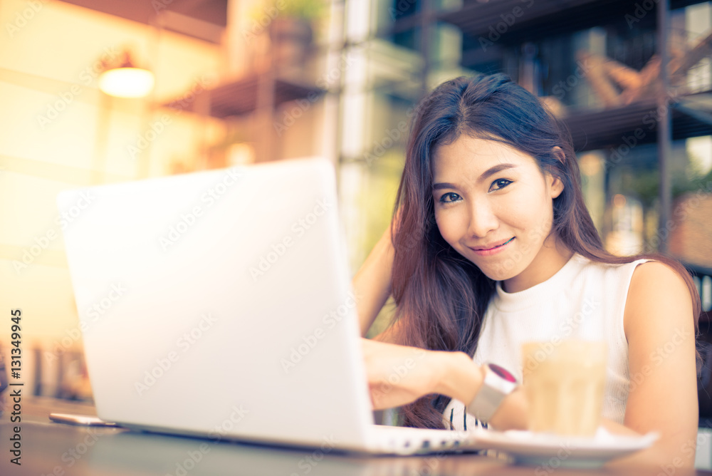 Asian woman drinking coffee in vintasg color tone