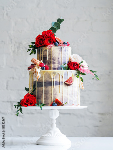 Wedding cake with flowers, figs, macarons and blueberries