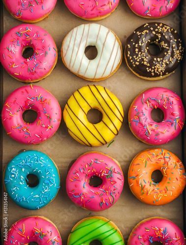 Colorful donuts in takeaway box
