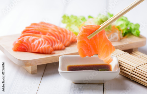 salmon sashimi  with chopsticks. photo