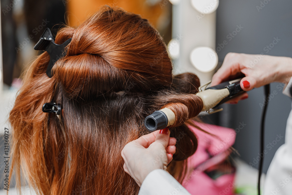Hairdresser working at the beauty studio salon, making hair styl Hairdresser working at the beauty studio salon, making hair styl