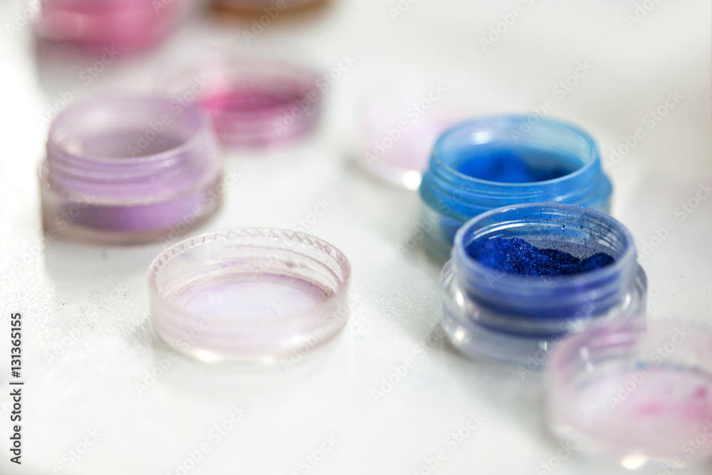 Professional cosmetics. Eye-shadows of different colors. jars with coloured glitter makeup Professional cosmetics. Eye-shadows of different colors. jars with coloured glitter makeup