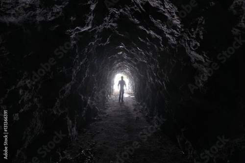 Man explores a cave © marcobarone