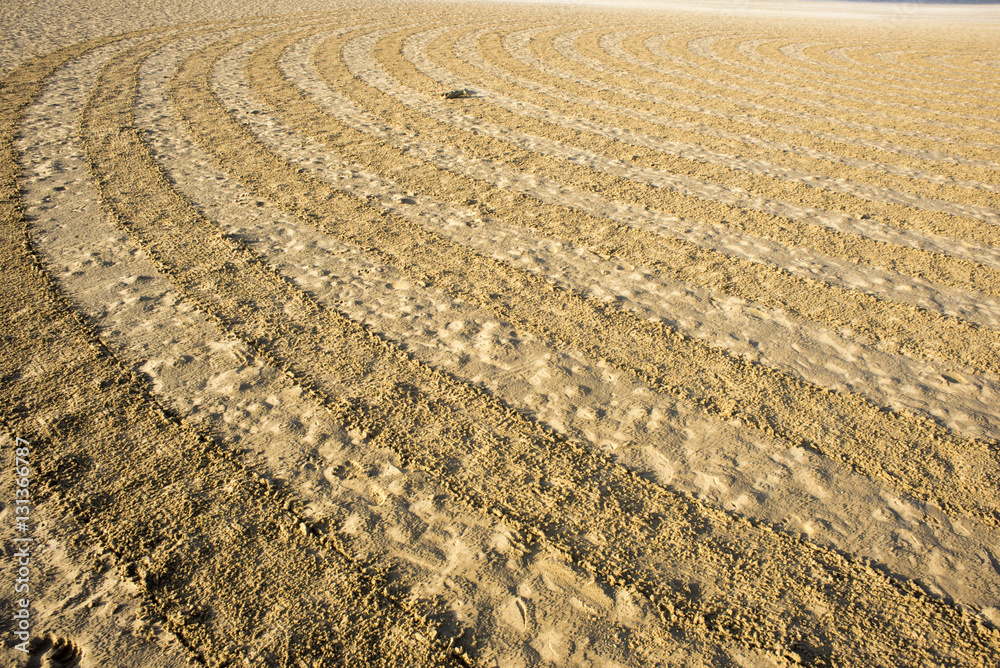 Circular design in raked on the beach Circular design in raked on the beach