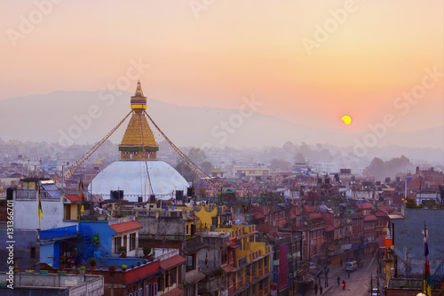 Kathmandu city view on the early morning on sunrise with rising sun and famous buddhist Boudhanath Stupa temple. Tibetan traditional architecture, Nepal. photo