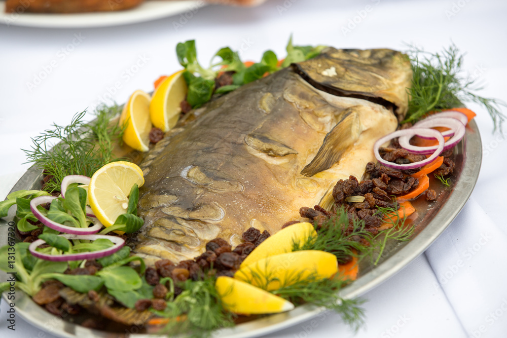 carp with lemon, dill and raisins on plate carp with lemon, dill and raisins on plate