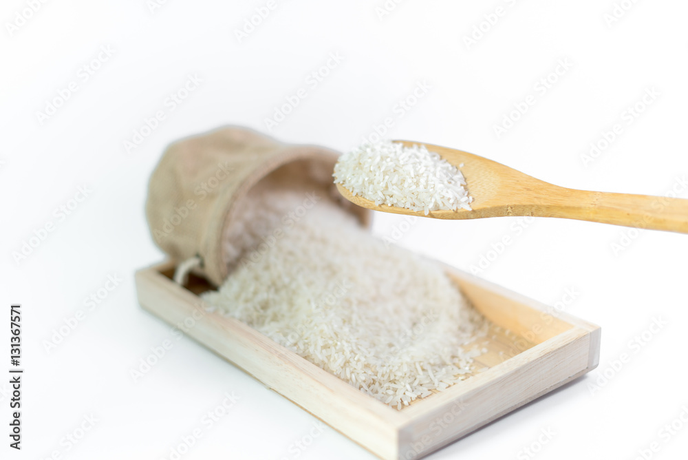 White long rice in a sack and wooden scoop isolated on white background