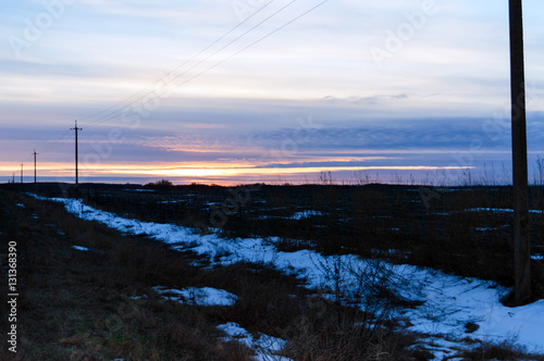 Sunset over the field  in some places covered with snow. December  Ukraine.