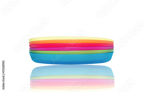 Bright plastic disposable tableware isolated on white with reflection