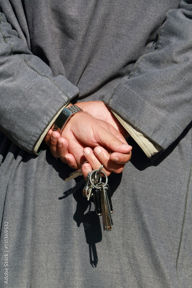 Unrecognizable man with arabic dress and hands on his back. Vertical image Unrecognizable man with arabic dress and hands on his back. Vertical image