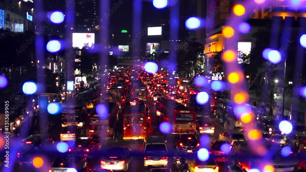 BANGKOK, THAILAND - Aerial view on road. Road traffic in night from high above. View from garland with colorful light bulbs. BANGKOK, THAILAND - Aerial view on road. Road traffic in night from high above. View from garland with colorful light bulbs.