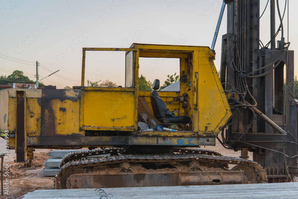 old yellow powerful construction machinery , focused beside of machinery.