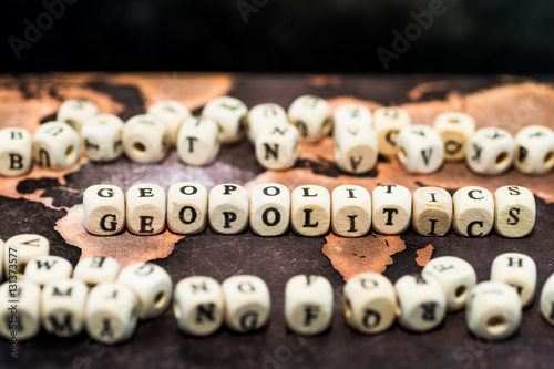 Wooden blocks forming the word geopolitics on table photo