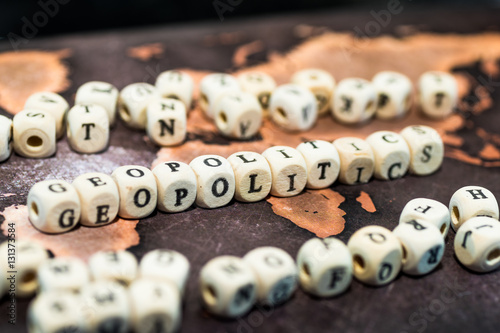 Wooden blocks forming the word geopolitics on table photo