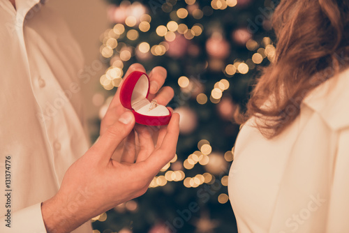 Close up of young  man making proposal of marriage on Christmas photo