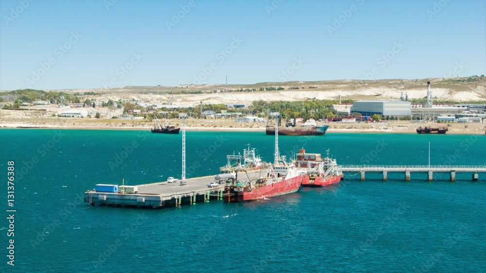 Puerto Madryn Argentina Industrial Dockyard with Industry Boats and Vehicles on a Sunny South American Day Puerto Madryn Argentina Industrial Dockyard with Industry Boats and Vehicles on a Sunny South American Day