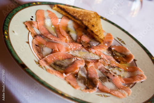 Delicious slices of salmon carpaccio in restaurant