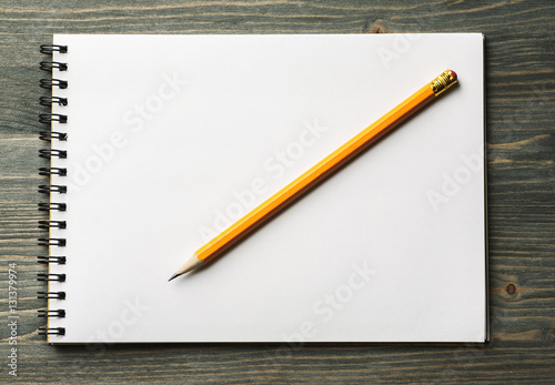 White notepad with pencil on it overhead view